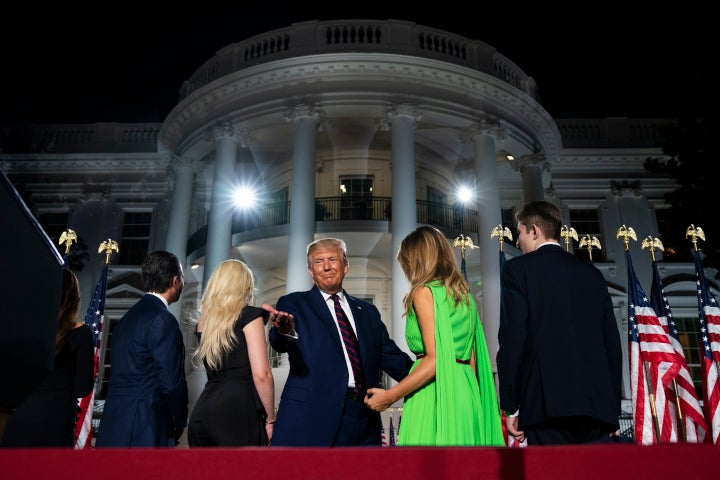 The president and his family standing before the White House — a federal government building they used as a prop for hi