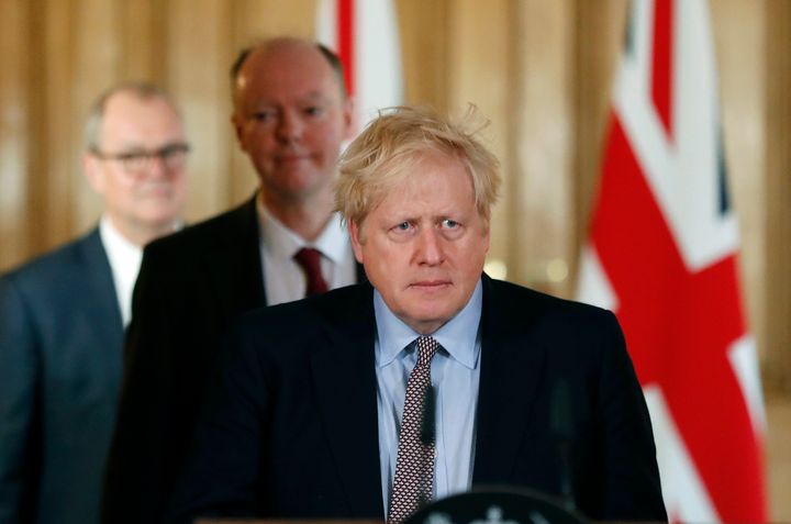 Boris Johnson arrives for a press conference with chief medical adviser to the UK government, Chris Whitty and the chief scientific adviser Patrick Vallance.