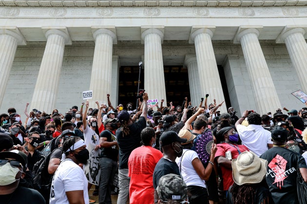 WASHINGTON, DC - AUGUST 28: Protesters stand on the Lincoln Memorial during the Commitment March on August 28, 2020 in Washington, DC.  Rev. Al Sharpton and the National Action Network organized a march with families who lost loved ones to police brutality, calling for criminal justice reform and demanding changes to federal legislation against police misconduct.  Today would mark the 57th anniversary of Martin Luther King Jr.'s March on Washington. (Photo by Natasha Moustache/Getty Images)