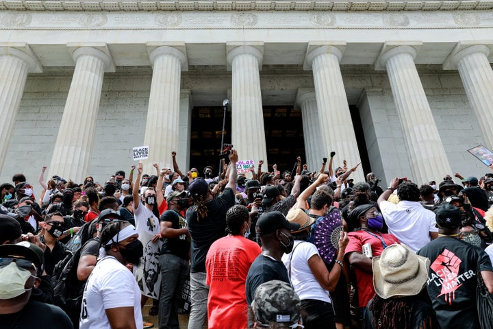 WASHINGTON, DC - AUGUST 28: Protesters stand on the Lincoln Memorial during the Commitment March on August 28, 2020 in Washington, DC. Rev. Al Sharpton and the National Action Network organized a march with families who lost loved ones to police brutality, calling for criminal justice reform and demanding changes to federal legislation against police misconduct. Today would mark the 57th anniversary of Martin Luther King Jr.'s March on Washington. (Photo by Natasha Moustache/Getty Images)