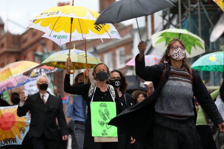 Protesters from Extinction Rebellion take part in a "Procession for the Planet" through the streets of Lewes on August 29, 2020