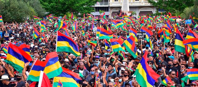 Tens of thousands of people protest in Port Louis, Mauritius, Saturday Aug. 29, 2020, over the government's slow response to an oil spill from a grounded Japanese ship and the alarming discovery of dozens of dead dolphins . (Beekash Roopun/L'express Maurice via AP)