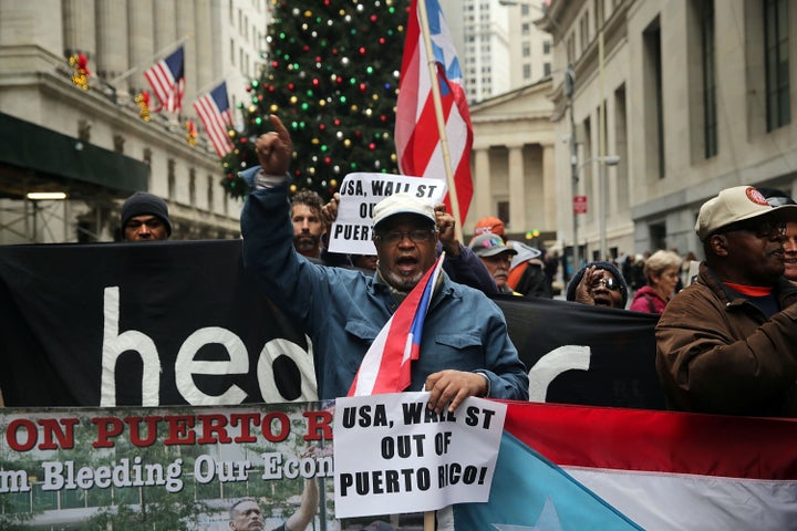 Puerto Rican protesters march on Wall Street in New York City in 2015, which activists blame for worsening the island's debt