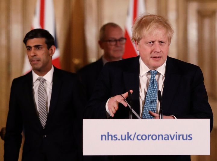 Chancellor Rishi Sunak and Prime Minister Boris Johnson arrive for a coronavirus press briefing.