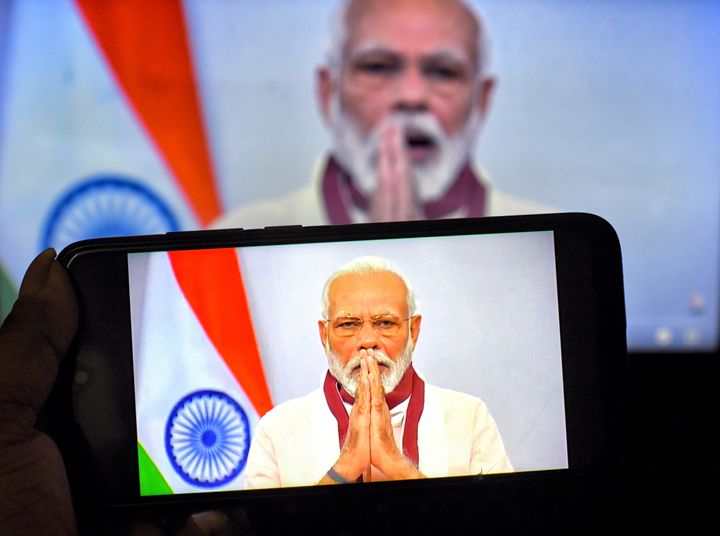 In this photo illustration, Prime Minister Narendra Modi is found speaking to the Nation about Covid19 crisis on a smartphone. 