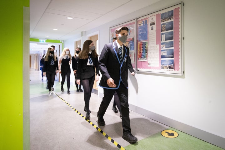 <strong>Students at St Columba's High School, Gourock, wear protective face masks as they head to lessons on Monday.</strong>