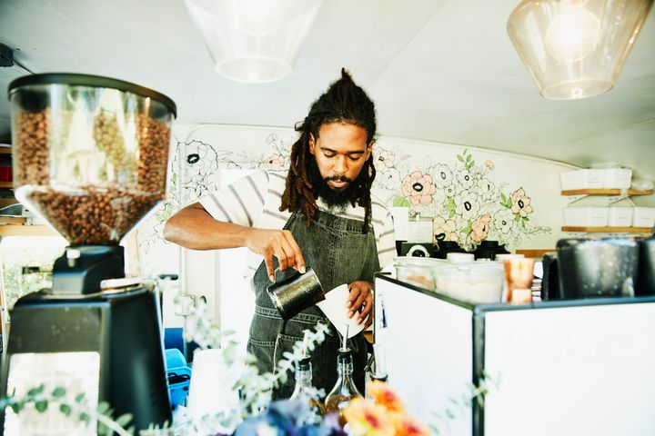 Barista pouring coffee in coffee truck