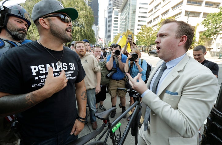 Joey Gibson, left, is the founder of Patriot Prayer. In this August 2018 file photo, he argues with a bystander following a rally supporting gun rights at City Hall in Seattle.