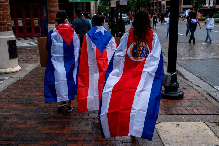 Protesters wear Cuban, Puerto Rican and Costa Rican flags during an anti-racist protest in Orlando, Florida, after the killing of George Floyd this spring. While Trump has accused Joe Biden of favoring radical "socialism" and fomenting unrest, the Biden campaign has begun to compare Trump's response to the protests to the authoritarian tendencies of the Latin American leaders the U.S. president claims to oppose.