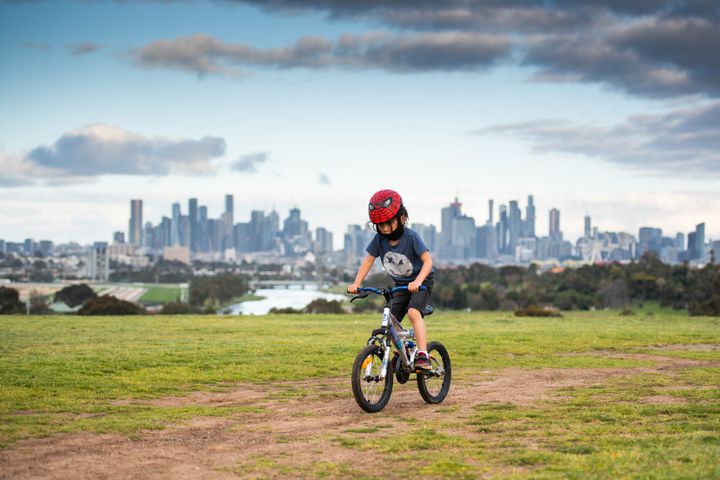 A boy rides bicycle in Melbourne, Victoria, Australia. 