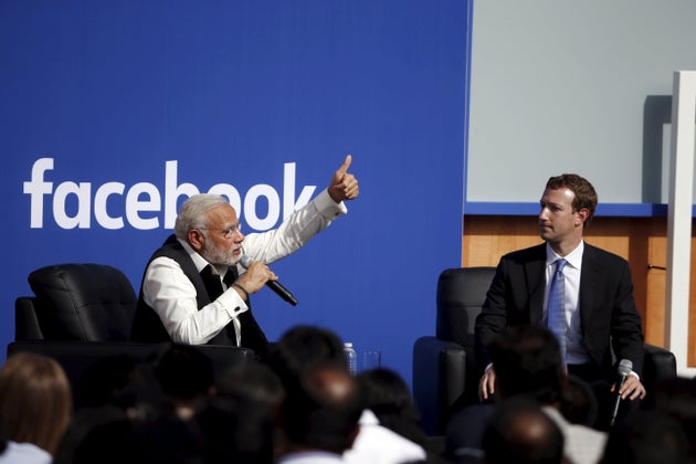Indian Prime Minister Narendra Modi (L) and Facebook CEO Mark Zuckerberg speak on stage during a town...