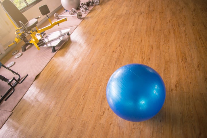 High Angle View Of Fitness Ball On Hardwood Floor In Gym