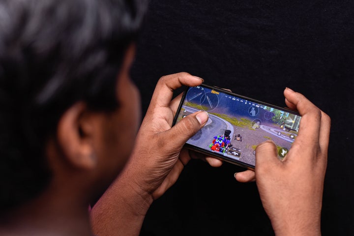 A boy playing PUBG on his smartphone. 