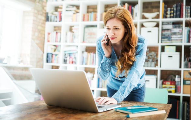 Woman using smartphone and laptop