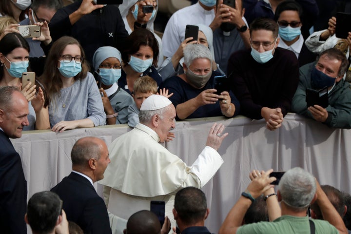 Pope Francis waves as he arrives for his first general audience in months on Wednesday, Sept. 2, 2020.