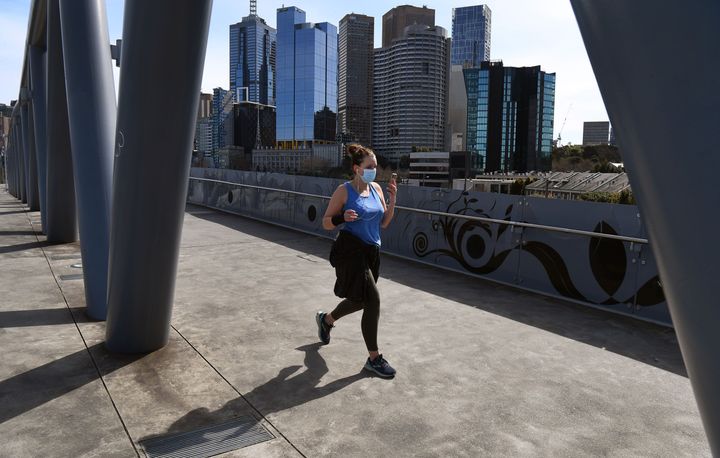 People exercise on the edge of Melbourne's central business district on September 1, 2020, with the city in a strict lockdown as it battles a COVID-19 coronavirus outbreak. 