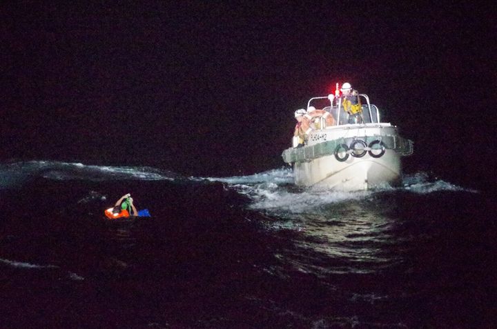 A Filipino crew member believed to be onboard Gulf Livestock 1 is seen being rescued by a Japan Coast Guard boat.