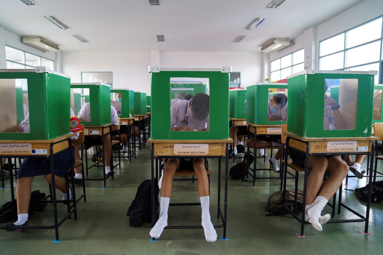 Students wearing face masks and face shields are seen inside old ballot boxes repurposed into partitions as they attend class at Sam Khok School in the province of Pathum Thani, Thailand, on July 1.