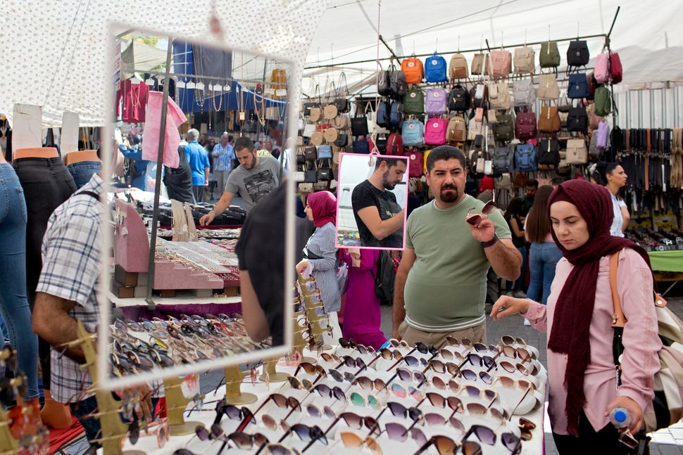 Vendors switch from selling sunglasses to face masks at a stall in the Fatih Market in Istanbul, where wearing a mask in public is mandatory. Markets are an essential part of life in Istanbul, and every neighborhood has its own. Any given market is usually cramped, but since the pandemic, markets are empty compared to what they once were. Above: July 31, 2019 | Below: July 29, 2020