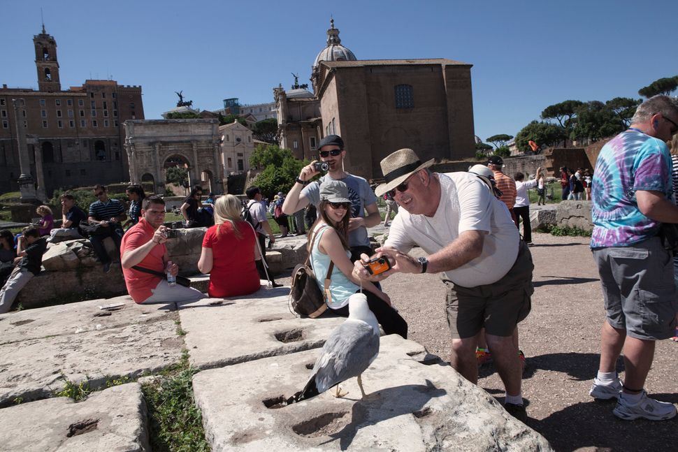 According to the Italian Ministry of Cultural Heritage and Activities, in 2019, more than 55 million tourists visited museums and archeological sites in Rome, such as the Roman Forum, pictured here. Access to the site has been restricted to reservation-only. Above: May 29, 2015 | Below: July 31, 2020
