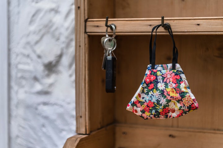 Hanging clean masks by the front door on a hook or coat rack may help you remember to grab it when you leave the house.