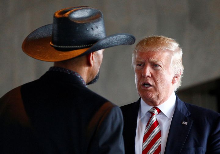 Donald Trump talks with then-Milwaukee County Sheriff David Clarke Jr. during the 2016 presidential campaign.