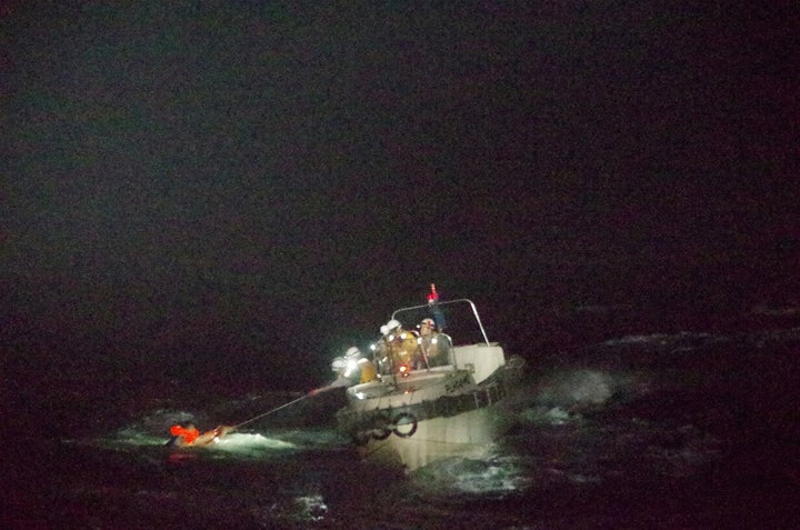 A Filipino crew member believed to be onboard Gulf Livestock 1, a cargo ship carrying livestock and dozens of crew members that went missing after issuing a distress signal due to Typhoon Maysak, is rescued by a Japan Coast Guard boat.