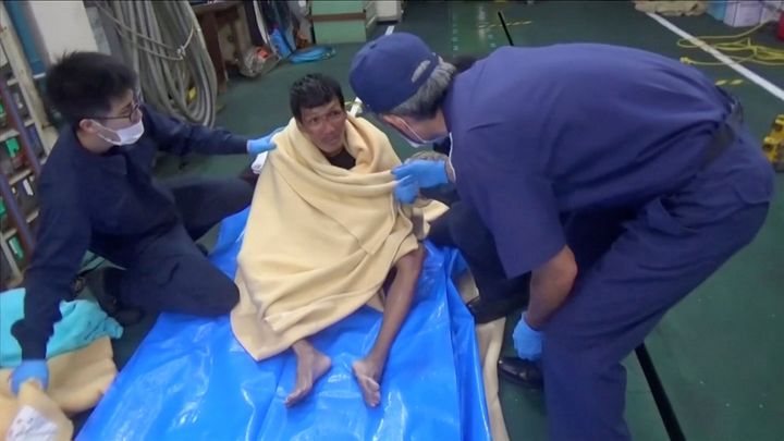 A Filipino crew member from the missing livestock ship, Gulf Livestock 1, is seen after being rescued by the Japan Coast Guard off the coast of Japan. 