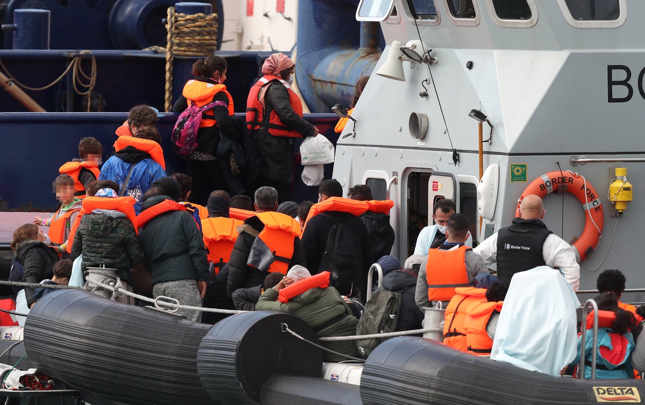 A group of people thought to be migrants are brought into Dover, Kent, by Border Force officers following a small boat incident in the Channel. 