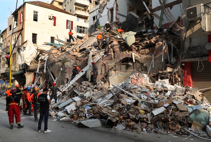 Chilean and Lebanese rescuers search in the rubble of a building that was collapsed in last month's massive explosion, after getting signals there may be a survivor under the rubble, in Beirut, Lebanon, Thursday, Sept. 3, 2020. (AP Photo/Bilal Hussein)