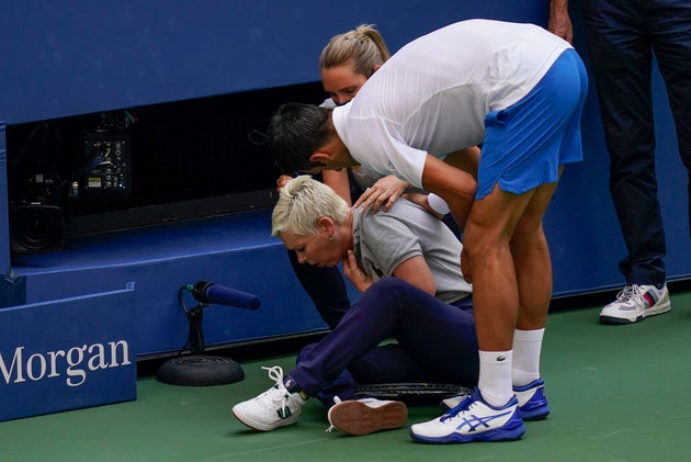 Djokovic checks a the linesman after hitting her with a ball in reaction to losing a point to Pablo Carreno Busta.