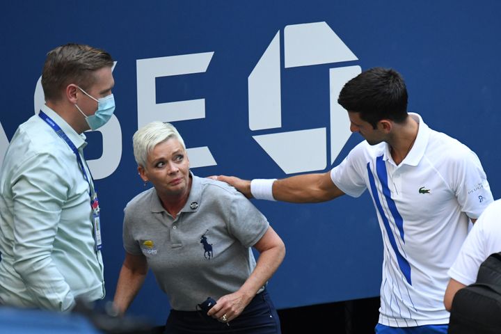 Novak Djokovic of Serbia and a tournament official tend to a linesperson who was struck with a ball by Djokovic against Pablo Carreno Busta of Spain (Mandatory Credit: Danielle Parhizkaran-USA TODAY Sports/Sipa USA