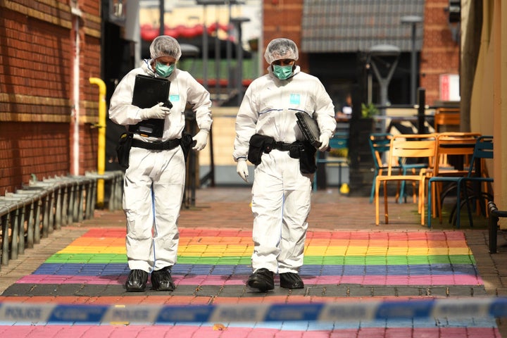 Police forensics officers gathering evidence at the scene of the attack 