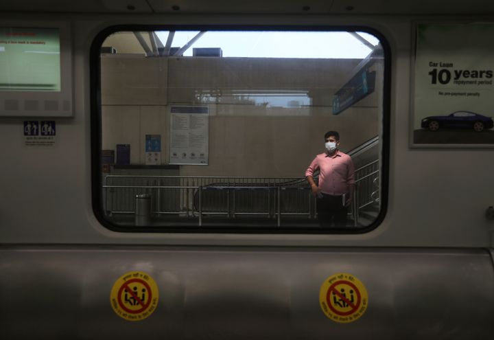 A commuter waits for the next rapid metro train at a station in Gurugram on the outskirts of New Delhi, India, Monday, Sept. 7, 2020.
