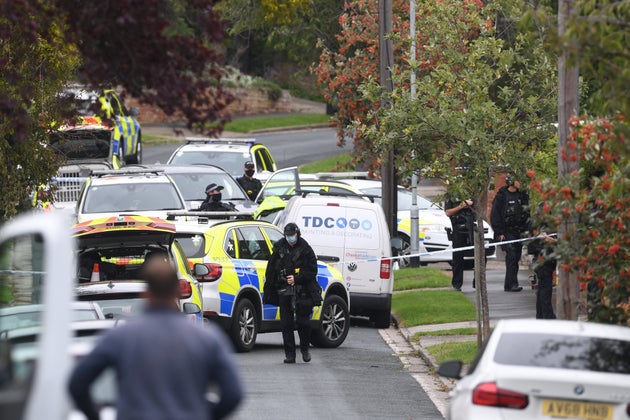 Armed police officers outside a property on Westwood Avenue, Ipswich, a few miles from Grange Farm in Kesgrave, Suffolk, where police were called to reports of a shooting just after 8.40am this morning.