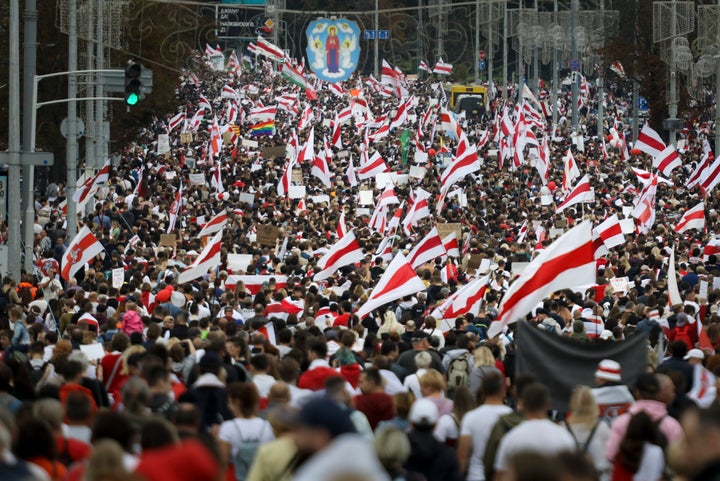 Protesters with old Belarusian national flags march during an opposition supporters rally in Minsk, Belarus, on Sept. 6, 2020. 