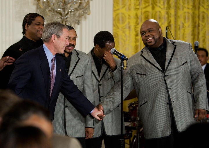 President George W. Bush shakes hands with Bruce Williamson of The Temptations on Feb. 12, 2008 at White House in Washington, DC. 