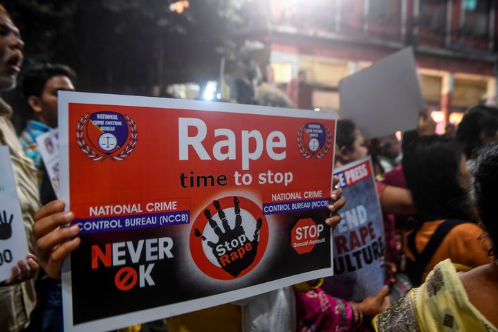 Demonstrators hold placards to protest against sexual assault on women, in Kolkata on December 4, 2019. 