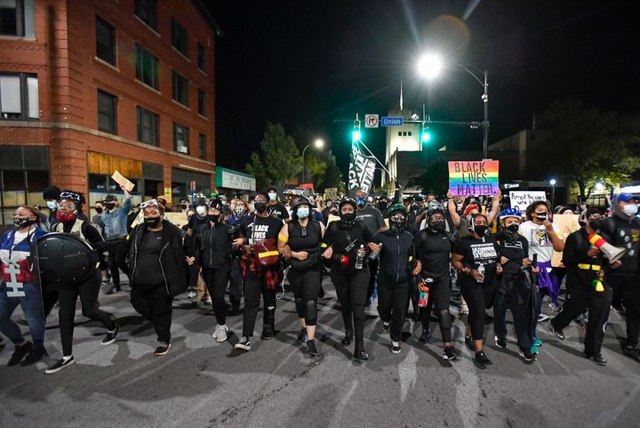 Demonstrators march along a street in Rochester, N.Y., Friday, Sept. 4, 2020, during a protest over the death of Daniel Prude. (AP Photo/Adrian Kraus)
