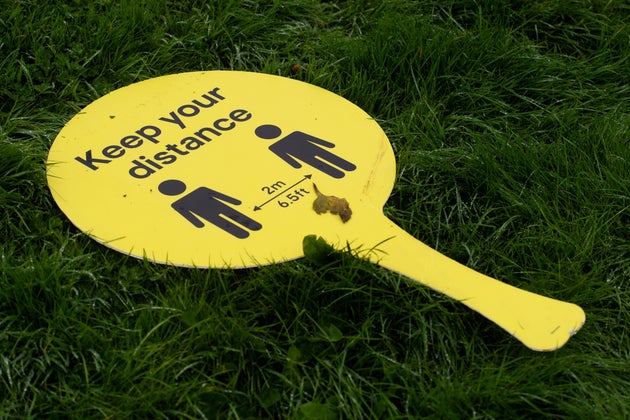 A discarded sign encouraging social distancing on September 08, 2020 in Caerphilly, United Kingdom.