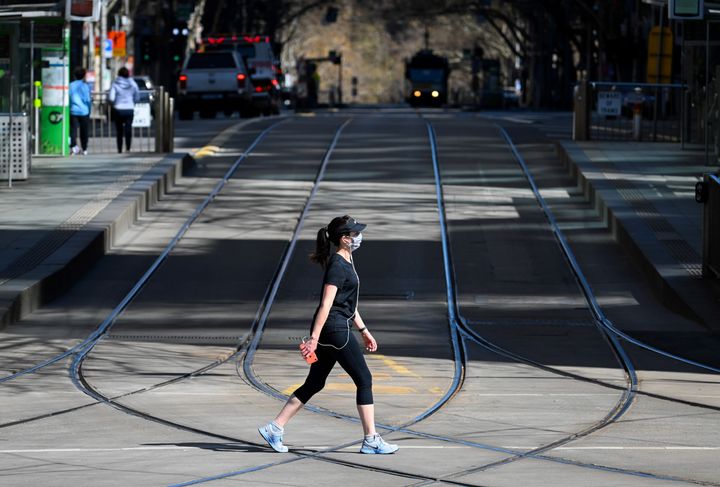 A woman takes a walk in Melbourne on September 6, 2020 as the state announced an extension to its strict lockdown law while it battles fresh outbreaks of the COVID-19 coronavirus. 