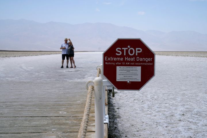 A sign warns of extreme heat danger at Badwater Basin, Monday, Aug. 17, 2020, in Death Valley National Park, Calif. (AP Photo/John Locher)