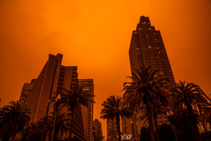 An orange glow fills the sky above the Embarcadero as smoke from various wildfires burning across Northern California mixes with the marine layer, blanketing San Francisco in darkness.