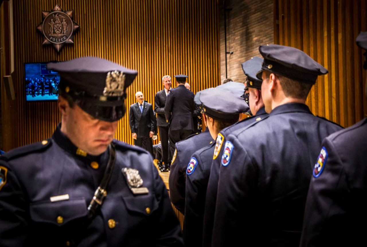 Mayor Bill de Blasio and Bratton congratulate officers at a promotion ceremony in 2014. (Mark Peterson/Redux)