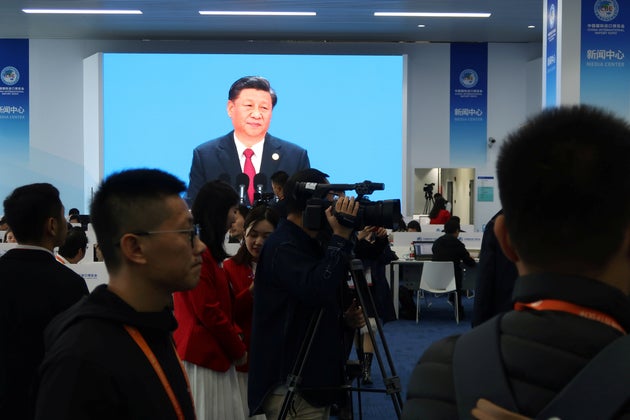 Chinese President Xi Jinping is seen on a screen at the media center as he delivers a speech at the opening...