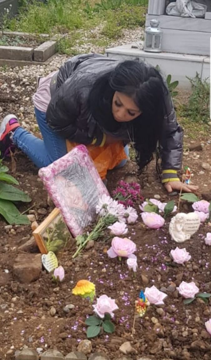 Mel Mustafa at sister's graveside 