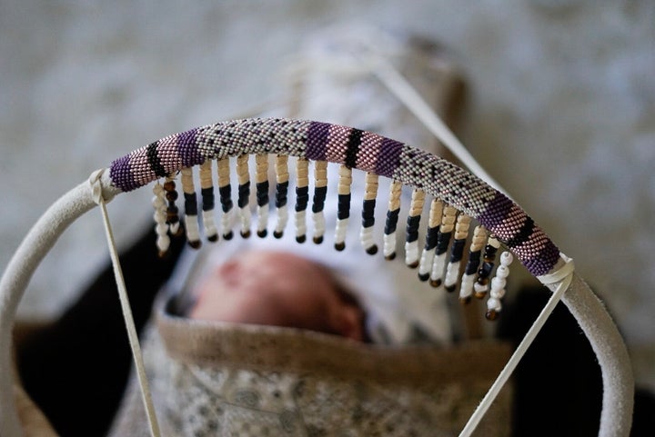 Chelsey's daughter, Alo Akawe, a few days old at home in her cradleboard.