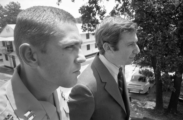 Captain Jeffrey MacDonald (L) is shown in 7/17/1970 file photo conferring with his attorney, Dennis Eisman. MacDonald was seized by the military police and his two attorneys, Bernard Segal and Eisman were roughed up, a witness reported, and taken to a hospital where Eisman was checked for injuries. The Army confirmed MacDonald had been taken into custody, but would not elaborate. (Photo by Bettmann Archive/Getty Images)