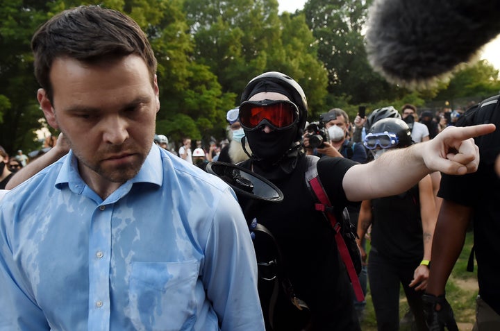 Far-right pro-Trump propagandist and One America News correspondent Jack Posobiec is escorted out of Lincoln Park by anti-racism protesters in Washington, D.C., on June 26.