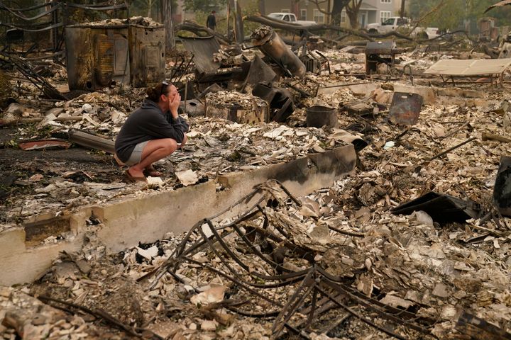 Desiree Pierce cries as she visits her home destroyed by the Almeda Fire, Friday, Sept. 11, 2020, in Talent, Ore. "I just needed to see it, to get some closure," said Pierce.